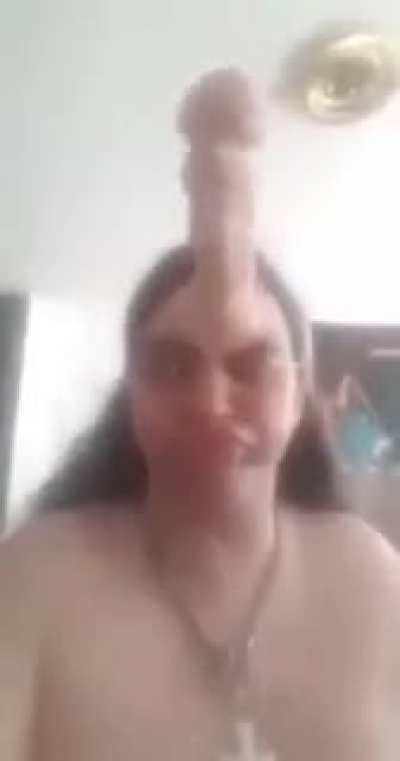 Guy putting a skin color dildo on his forehead template