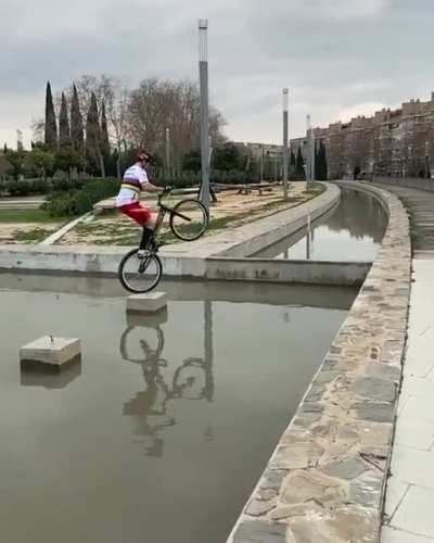 Jumping a wheelie bike across water channel