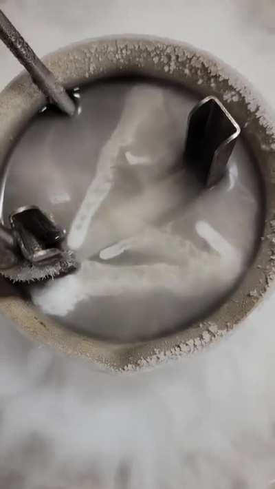 Liquid nitrogen poured over another liquid