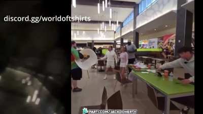 Dude in rainbow shirt sprays bottle of mustard on streamers at the mall