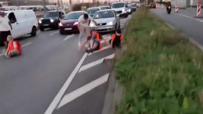 German citizens removing climate protesters from roads.