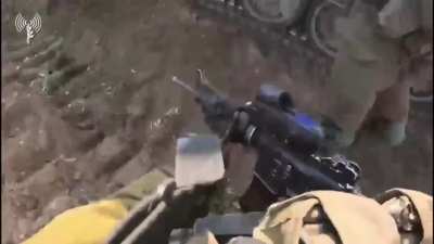 Israeli troops battling Hamas gunman shooting from a tunnel entrance.