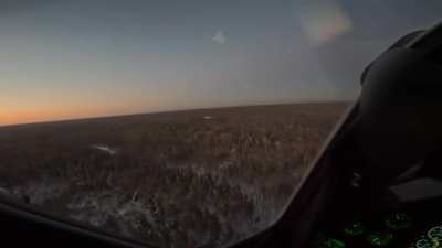 RU POV: A Russian Ka 52 pilot shoots down a drone with a single shot from its 2A42 30mm automatic cannon, firing two rounds with one hit. The drone crashes into the forest below