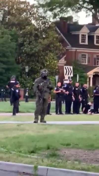 Police officer in Richmond, VA spits on and near a detained protester multiple times, during a pandemic.