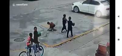 Kid gets yeeted after throwing a firecracker into manhole