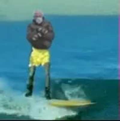 Bernie ripping on a longboard