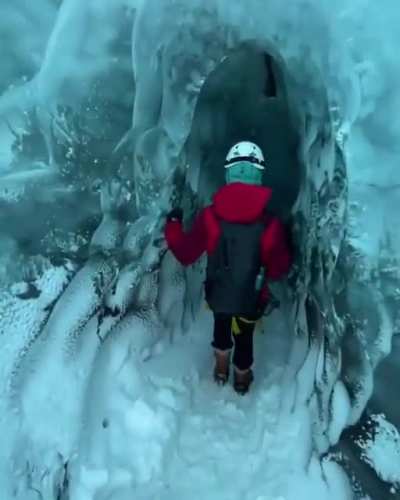 Person who is exploring a ice cave in Iceland