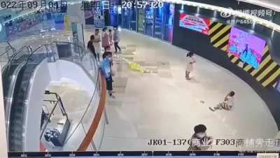 A chinese guy kicks a random kid after having an argument with his wife