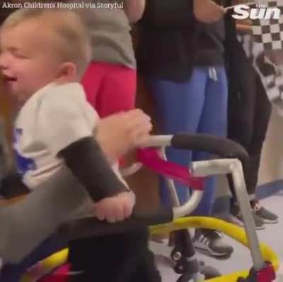 Toddler who was completely paralyzed months ago walks out of hospital by himself.