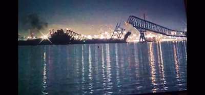 Massive ship hits large bridge, bridge collapses like house of cards. 