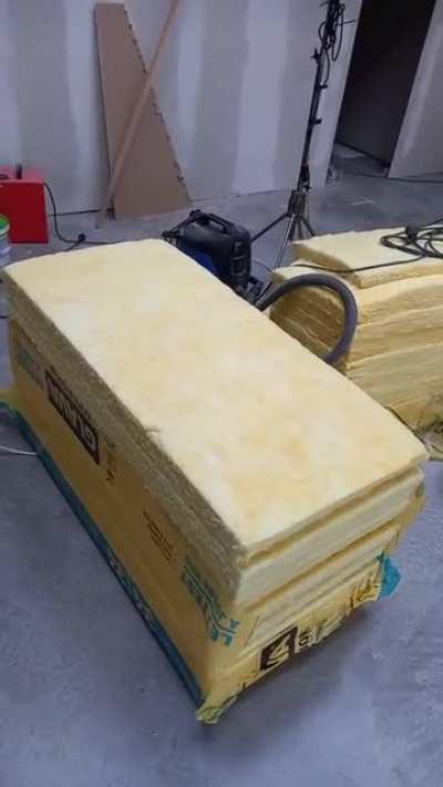 Cutting open a pack of insulation