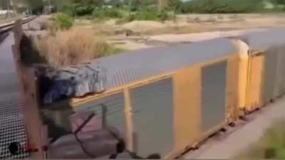 Train hauling cars is slightly too tall for the bridge