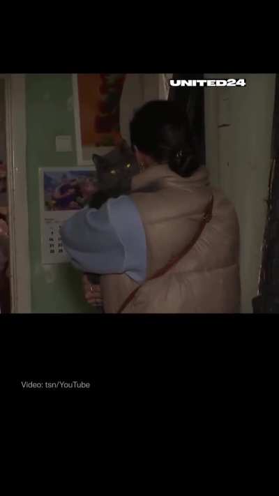 Woman finds her cat during an interview two days after a Russian attack that destroyed their home