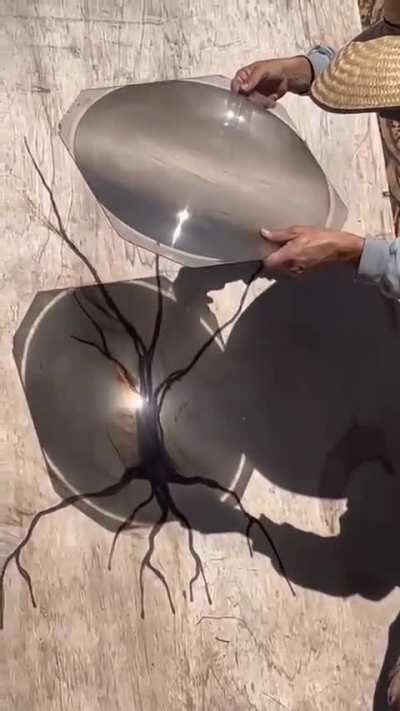 Dude uses sunray to burn art