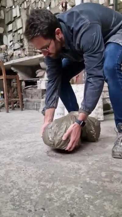 Artist carrying newly finished sculpture drops it on its face, the result is hilarious