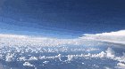 A neat POV of a plane passing by a giant storm system