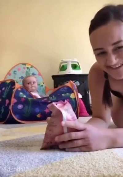 Baby knows that sound means snack time!