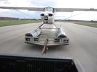 A seaplane taking off from a small flatbed