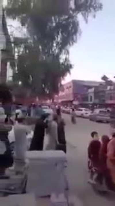Teens and kids wtih flags taunt Taliban fighters on a humveea, warning shots fired by Taliban