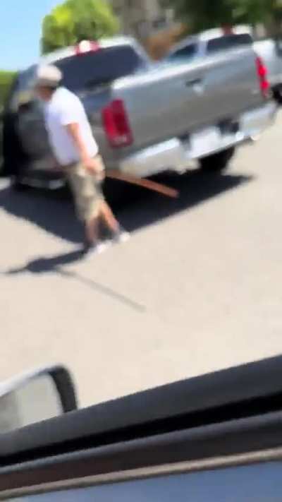 The man with the stick almost made the other driver run into a pole, the rest is history