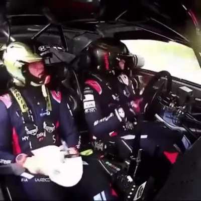 Rally car crashes while the pilot and his navigator calmly wait for the car to stop crashing.