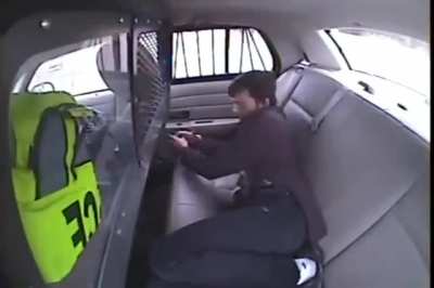 Guy tries to light cop car on fire