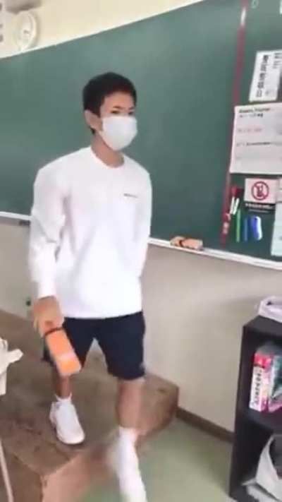 Guy uses the chalkboard eraser appropriately.