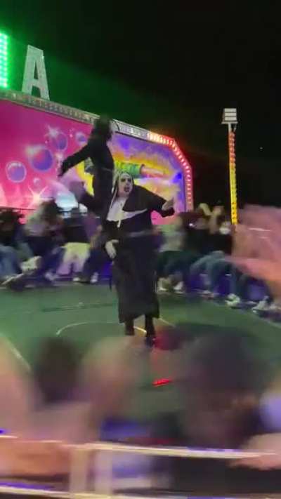 Dancing and jumping on spinning wheel ride at a theme park