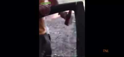 guy tries opening beer with glass window