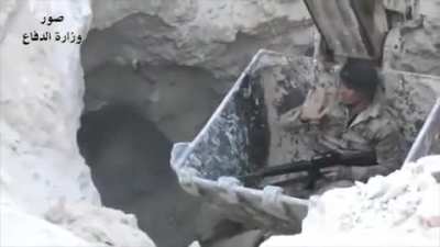 Soldier lowered into a tunnel in a excavator to clear ISIS militants.
