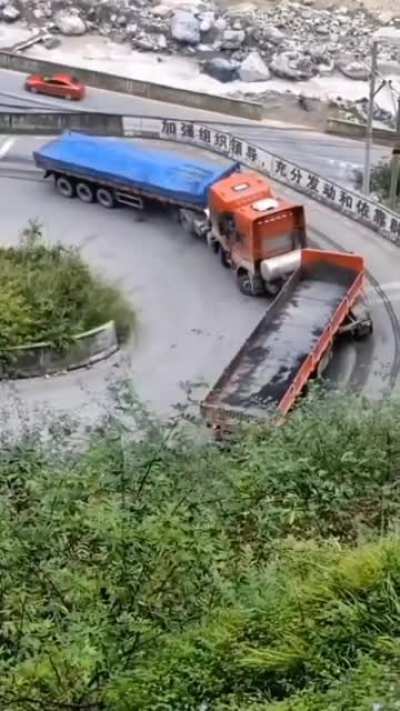 Two trucks on a narrow road.