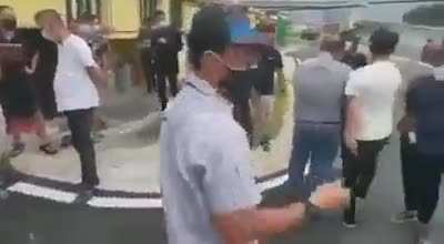 small riot in my country, lady in the middle just vibing.