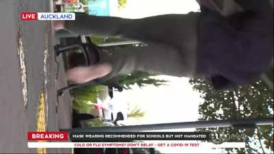 News crew get knocked over onto the ground.