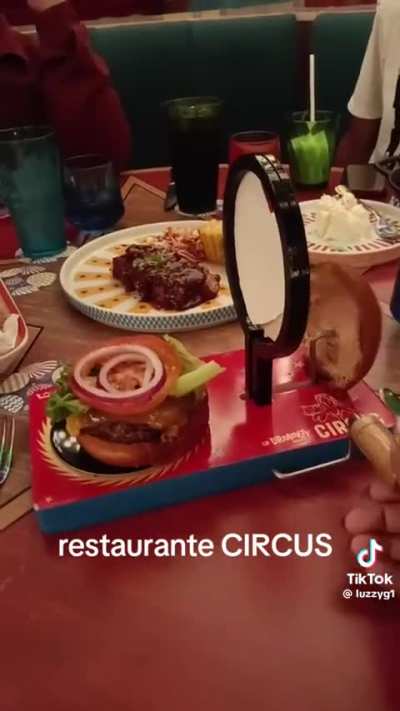 Circus performing burger does insane ring of fire trick 🔥