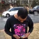 Rapper’s friend aims firecracker at dry lawn.