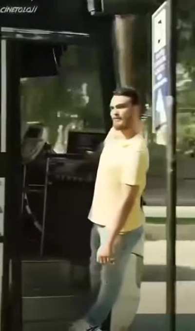 Smart guy riding on the outside of a bus