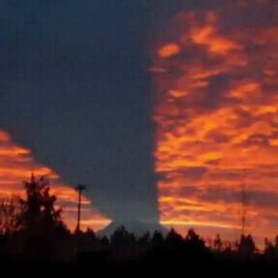 Mount Rainier casting its shadow across the clouds