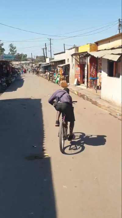African guy riding the bike like an absolute legend 🤯