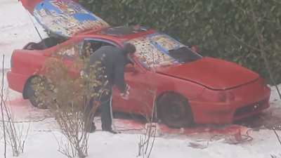 Neighbor is painting his red car red in the snow. Some masking but not on the wheels/tires, plus the windows are open. It's forecast to rain all day tomorrow.