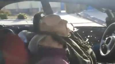 NSFW Elderly disabled couple shot close in a car by russian soldiers