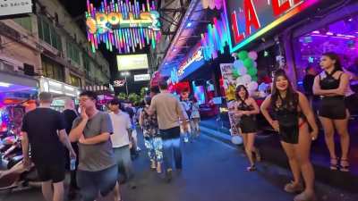 Thai girl points and laughs at disabled tourist