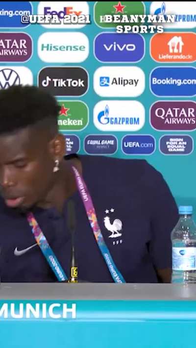 Paul Pogba removing Euro 2020 sponsor Heineken from in front of him during the press conference - credit Beanymansports
