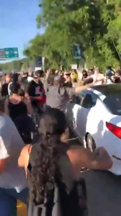 Crazy guy at protest smashes window onto 1-year old despite everybody else telling him not too