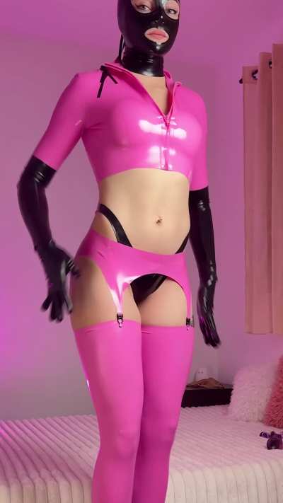 Pink latex dreams… with a darker twist underneath. 💋 How long could you keep eye contact before giving in?