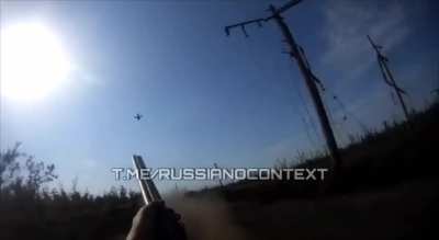 Russian soldiers with shotguns try to shoot down a Ukrainian FPV that is chasing their vehicle