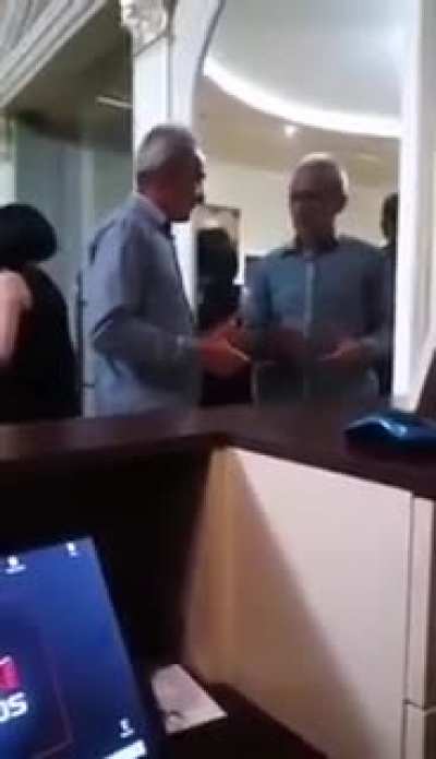 Two drunk gentlemen try to pass each other