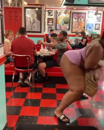 Woman twerkin in front of family at restaurant