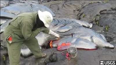 Scientist collecting lava samples