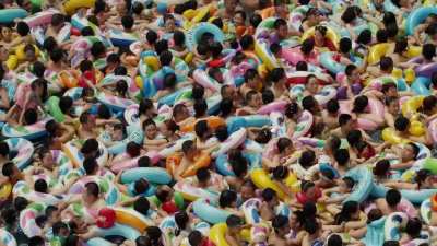 An overcrowded pool in a waterpark. Imagine you are stuck in the middle.