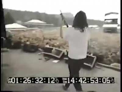 Gibby Haynes of the Butthole surfers fires a shotgun over the crowd at Lollapalooza 1991